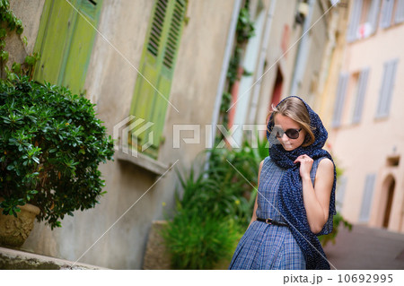 Elegant young woman in the Old town of Cannes 10692995