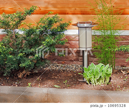 Solar-powered lamp on garden background. 10695328