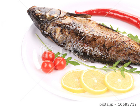 Fried carp with lemon and rukkola. Fried carp with lemon and rukkola. 10695713