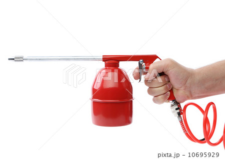 Hand holds spray gun with plastic spring. 10695929