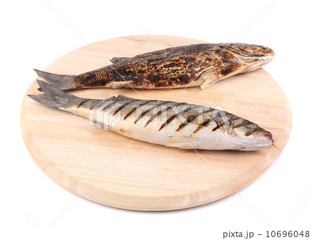 Two grilled seabass fish on platter. 10696048
