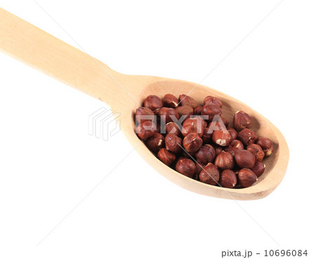 Wooden spoon with hazelnuts. Wooden spoon with hazelnuts. 10696084
