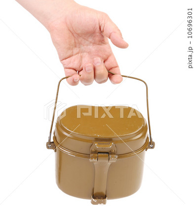 Hand holds military lunch box. Hand holds military lunch box. 10696301
