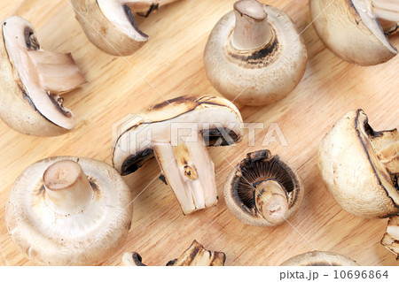White mushrooms on wooden board. 10696864