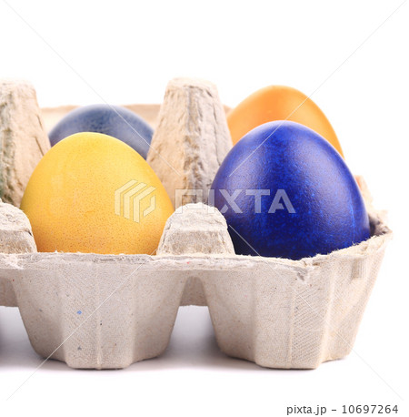 Cardboard egg box with Easter colored eggs 10697264