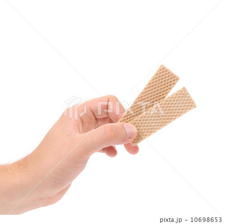 Hand holds wafer of chocolate. Hand holds wafer of chocolate. 10698653
