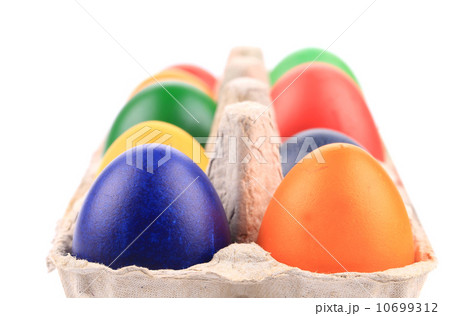 Cardboard egg box with Easter colored eggs Cardboard egg box with Easter colored eggs 10699312