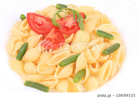 pasta shells with vegetables on white plate 10699335