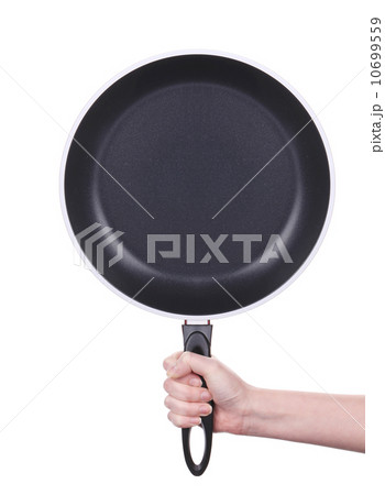 Hand holds a black frying pan 10699559