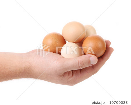 Hand holding brown eggs. 10700028