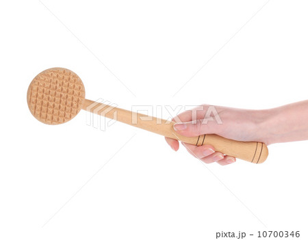 Hand holds wooden meat tenderizer. Hand holds wooden meat tenderizer. 10700346