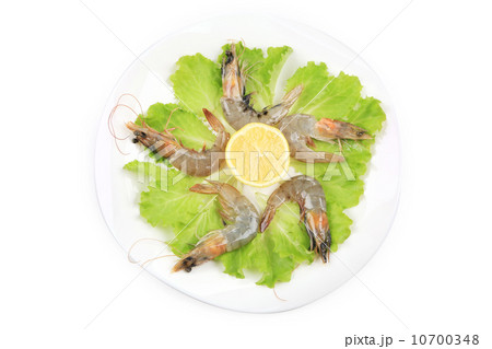 Raw shrimps on plate with lettuce and lemon. 10700348