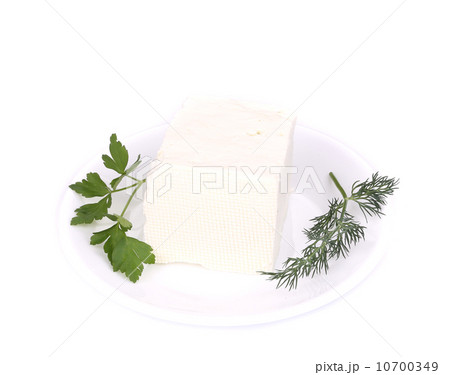 Sheep cheese on a white plate. 10700349