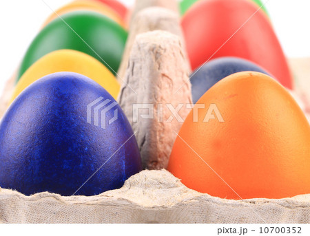 Cardboard egg box with colorful eggs. 10700352