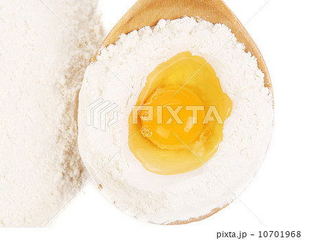 Egg with flour in a wooden spoon. 10701968