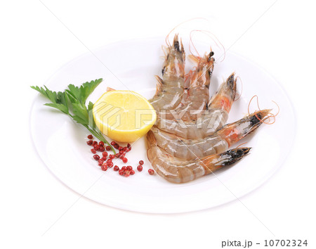 Raw shrimp with lemon and parsley. 10702324