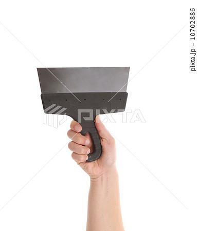 Hand holds metal spatula. Hand holds metal spatula. 10702886