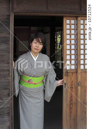 戸を開ける着物の女性の写真素材