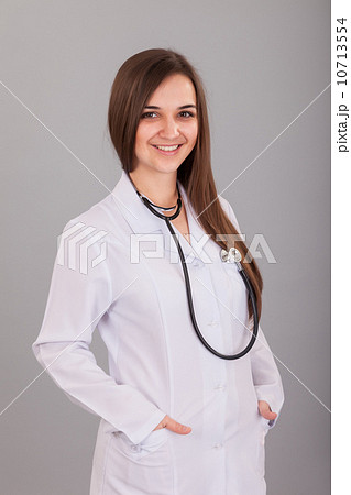 Young and beautiful nurse on a grey Young and beautiful nurse on a grey 10713554