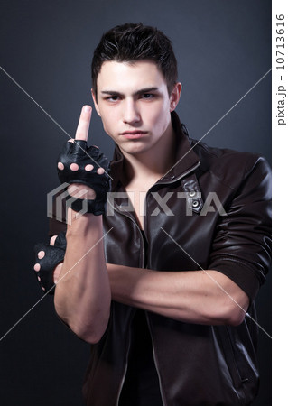 Angry handsome young man is showing a middle finger Angry handsome young man is showing a middle finger 10713616