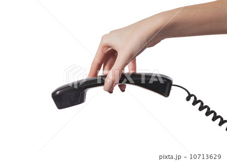 Hand holding an old black telephone tube 10713629