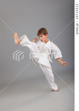 Karate boy in white kimono fighting 10714313