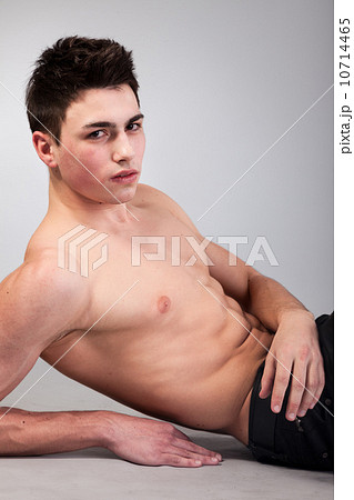 Healthy muscular young man on grey background 10714465