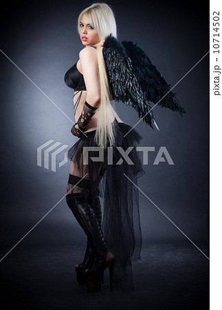 Blond female angel with black wings on a black background Blond female angel with black wings on a black background 10714502