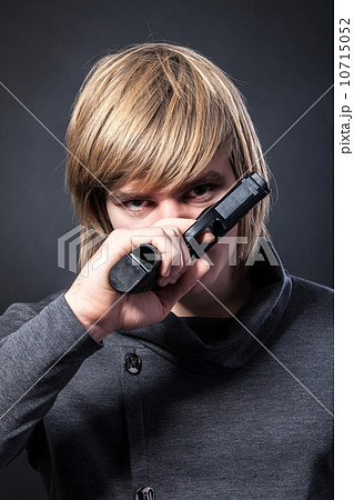 Aiming. Serious man with a gun 10715052