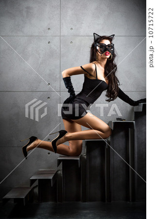 sexy woman in catwoman suit lying on stairs sexy woman in catwoman suit lying on stairs 10715722
