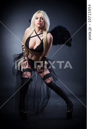 Blond female angel with black wings on a black background Blond female angel with black wings on a black background 10715954