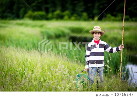 Young boy fishing in a river Young boy fishing in a river 10716247