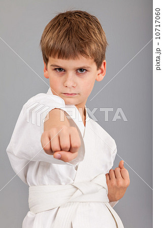 Karate boy in white kimono fighting 10717060