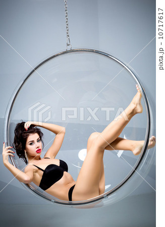 Sexy woman suspended from an aerial hoop Sexy woman suspended from an aerial hoop 10717617
