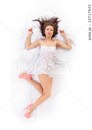 Portrait of beautiful young woman lying in bed Portrait of beautiful young woman lying in bed 10717643