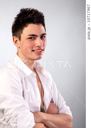 Healthy muscular young man on grey background Healthy muscular young man on grey background 10717967