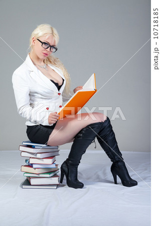 Beautiful student is sitting on the books Beautiful student is sitting on the books 10718185