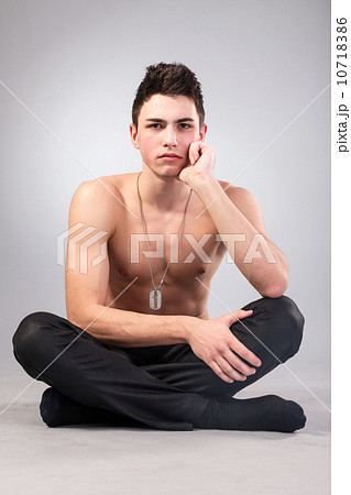 Healthy muscular young man on grey background Healthy muscular young man on grey background 10718386