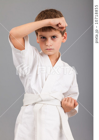 Karate boy in white kimono fighting Karate boy in white kimono fighting 10718855