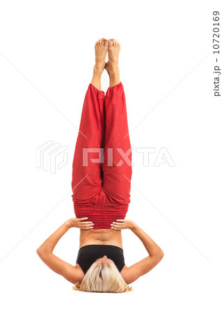 Practicing Yoga. Young woman isolated on white background Practicing Yoga. Young woman isolated on white background 10720169
