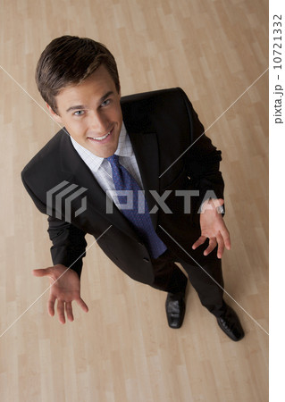Portrait of young smiling businessman gesturing 10721332