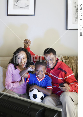 Parents with Son (12-13) watching sports on tv Parents with Son (12-13) watching sports on tv 10721875