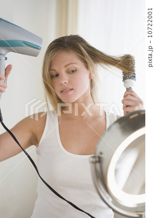 Woman drying hair Woman drying hair 10722001