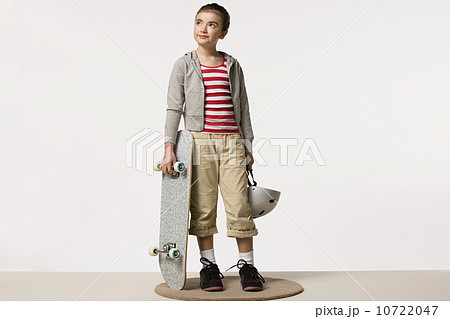 Studio portrait of girl (8-9) with skateboard Studio portrait of girl (8-9) with skateboard 10722047