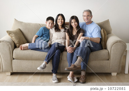 Cheerful family sitting on sofa 10722081
