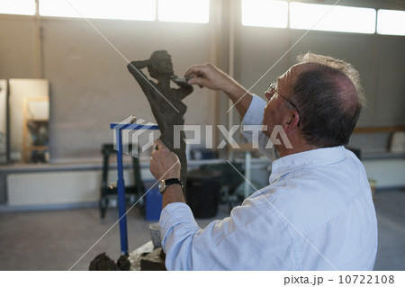 Retired man working on sculpture Retired man working on sculpture 10722108