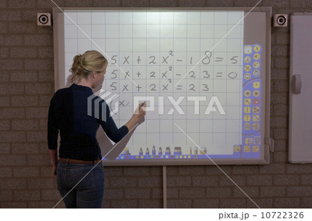 Teacher giving instructions at digital board 10722326