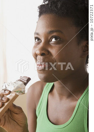 Woman eating chocolate bar Woman eating chocolate bar 10722371