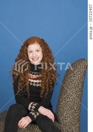 Portrait of teenage girl (16-17) sitting on chair 10722407