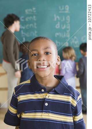 Portrait of boy (6-7) with schoolmates in background 10722413